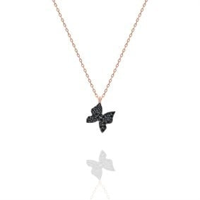 Butterfly-shaped necklace with black stones on a white background