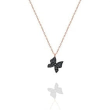 Butterfly-shaped necklace with black stones on a white background