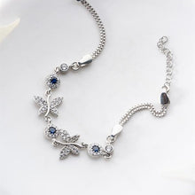 Silver bracelet with blue gemstones on a white background