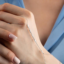 Silver bracelet on a wrist with a soft focus background