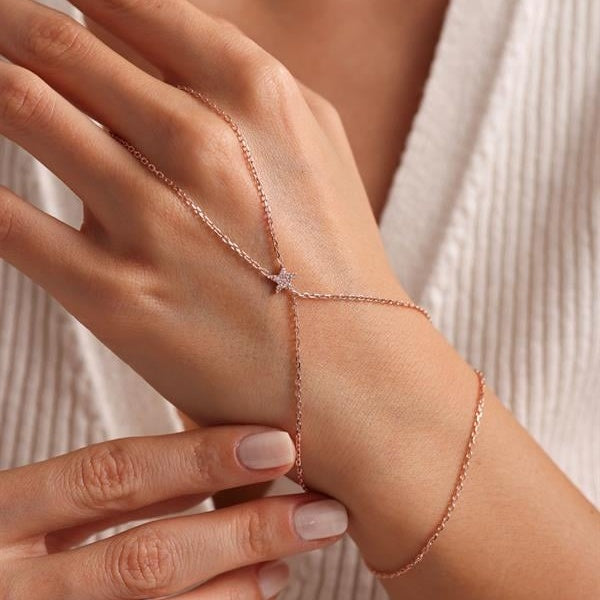 Rose gold bracelet on a wrist with a soft background