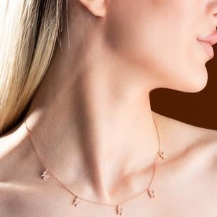 Close-up of a delicate necklace on a person's neck with a blurred background