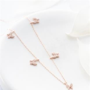 Rose gold butterfly necklace on a white background