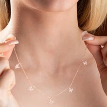 Necklace with butterfly pendants being worn by a person