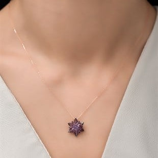Necklace with a purple flower pendant on a mannequin