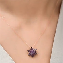 Necklace with a purple flower pendant on a mannequin