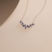 Necklace with blue gemstones on a beige background