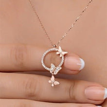 Rose gold necklace with butterfly pendants on a hand