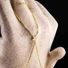 Gold necklace on a stone surface with a dark background
