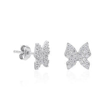 Butterfly-shaped earrings with sparkling details on a white background
