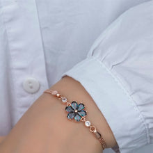 Bracelet with a floral design worn on a wrist against a light background