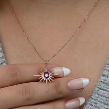 Necklace with a sun-shaped pendant held by a hand