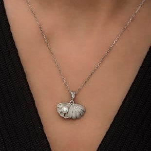 Silver necklace with a bear pendant on a black background