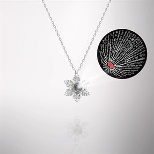 Snowflake-shaped necklace with a pearl center on a white background