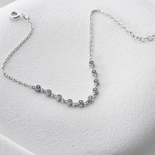 Silver bracelet with small stones on a white background