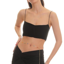 Woman wearing a black bikini top with a white background