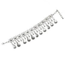 Silver bracelet with dangling beads on a white background