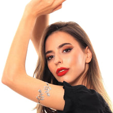 Woman wearing a silver leaf bracelet on a white background