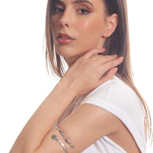 Woman wearing a silver bracelet on a white background