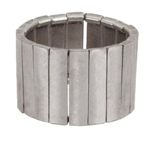 Silver ring with a ribbed design on a white background