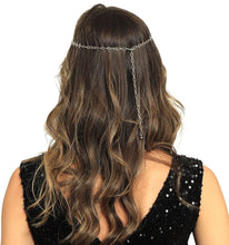 Person wearing a chain headpiece with long, wavy hair on a white background