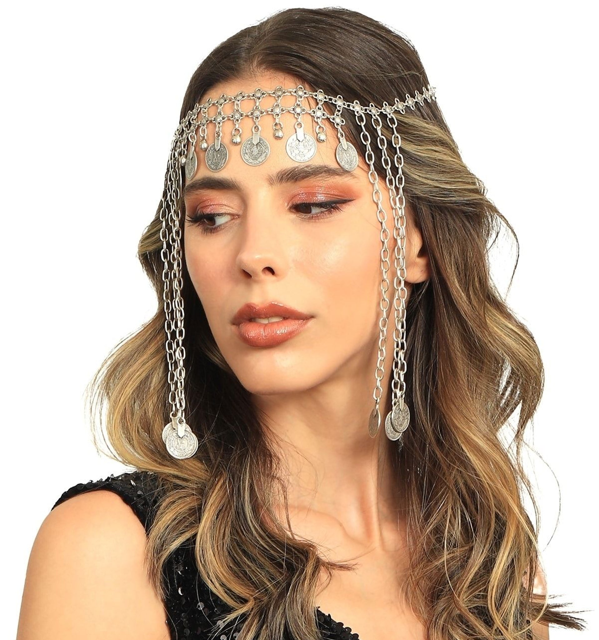 Woman wearing a silver chain headpiece with dangling elements on a white background