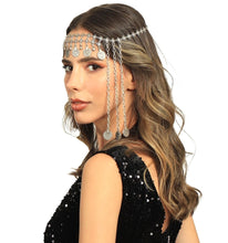 Woman wearing a decorative headpiece with chains and beads on a white background