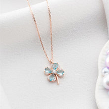 Rose gold necklace with a four-leaf clover pendant on a white background