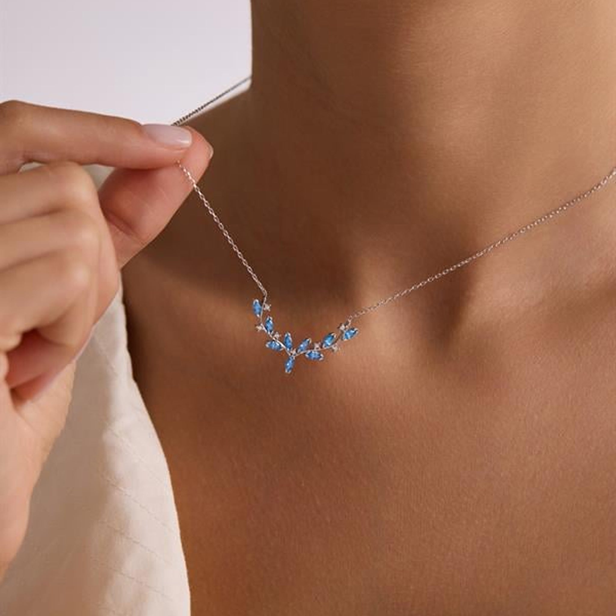 Necklace with blue stones being worn by a person