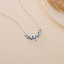 Necklace with blue gemstones on a beige background