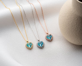 A delicate silver heart pendant with a stunning aquamarine birthstone.