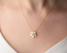 A nature-inspired sterling silver necklace featuring an ethereal opal gemstone in a blooming floral design.