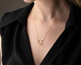 A handmade silver Saturn necklace styled with astrology and cosmic jewelry, ideal for celestial fashion lovers.