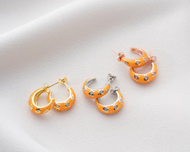 Close-up of handcrafted galaxy-inspired hoop earrings with cosmic colors and celestial detailing.