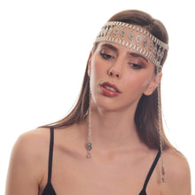 Woman wearing a decorative headband with chains on a white background