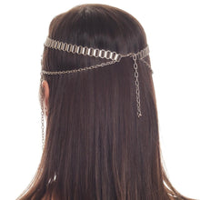 Silver chain headband worn by a person with long brown hair on a white background