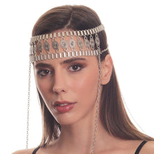 Woman wearing a silver headband with chains on a white background
