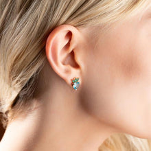 Close-up of a person wearing a pineapple-shaped earring.