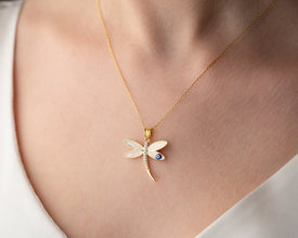 Close-up detail of dragonfly wings and Evil Eye gemstone