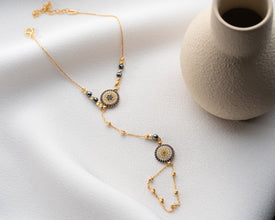 New mother wearing bracelet while holding baby carrier