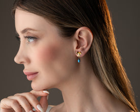 Lifestyle shot of Blue Ladybug Earrings in natural setting