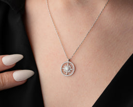  A boho-chic celestial necklace with a glowing sunbeam pendant, ideal for layering with other jewelry.