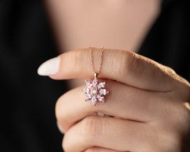 Handmade sterling silver magnolia necklace with a pink tourmaline gemstone, a delicate floral pendant for nature lovers.