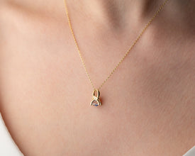 Close-up of a mystical Evil Eye pendant necklace with a deep blue gemstone for protection and cosmic energy