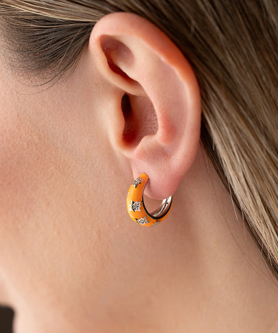 Gold hoop earrings inspired by celestial skies and galaxy hues.