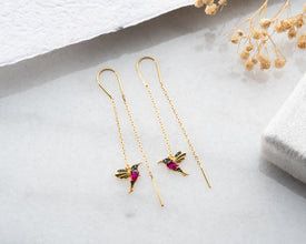 Model wearing lightweight handmade hummingbird earrings