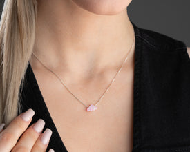 Minimalist jewelry featuring a pink opal cloud pendant in silver.