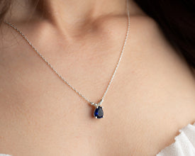 Minimalist oval blue sapphire necklace in sterling silver, perfect for everyday wear.