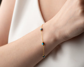 Model styling minimalist hematite necklace with white shirt