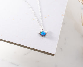 Close-up of an elegant opal bird pendant necklace, designed for spiritual jewelry lovers.